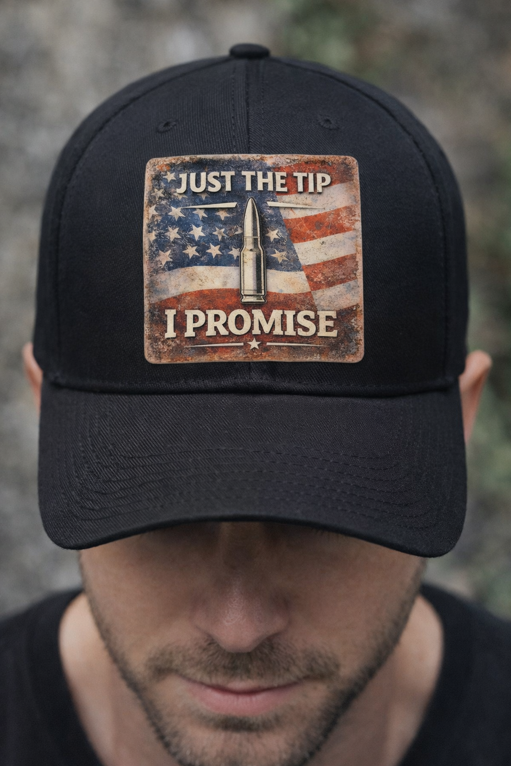 Black cap with Funny Patriotic DTF Transfer – “Just The Tip I Promise” – USA Flag worn by model against a grey background