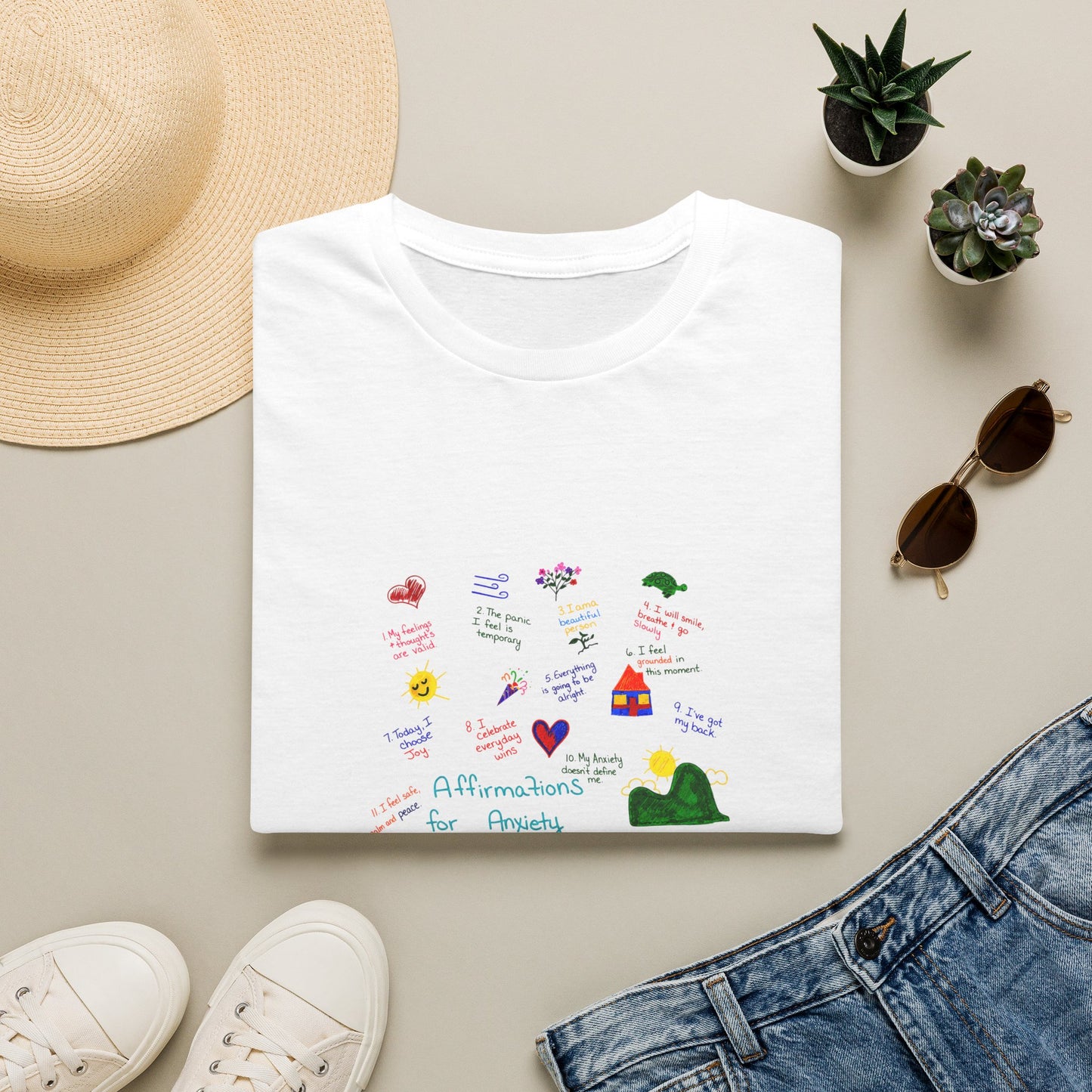 Affirmations for Anxiety Tee | Hand-Drawn Mental Health Graphic T-Shirt on a beige surface with accessories.