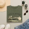Military Green Classic Pickup T-Shirt — "Life Is Better in a Classic" Vintage Truck Tee, styled in a flat-lay arrangement with a straw hat, sunglasses, and denim jeans on a white background.