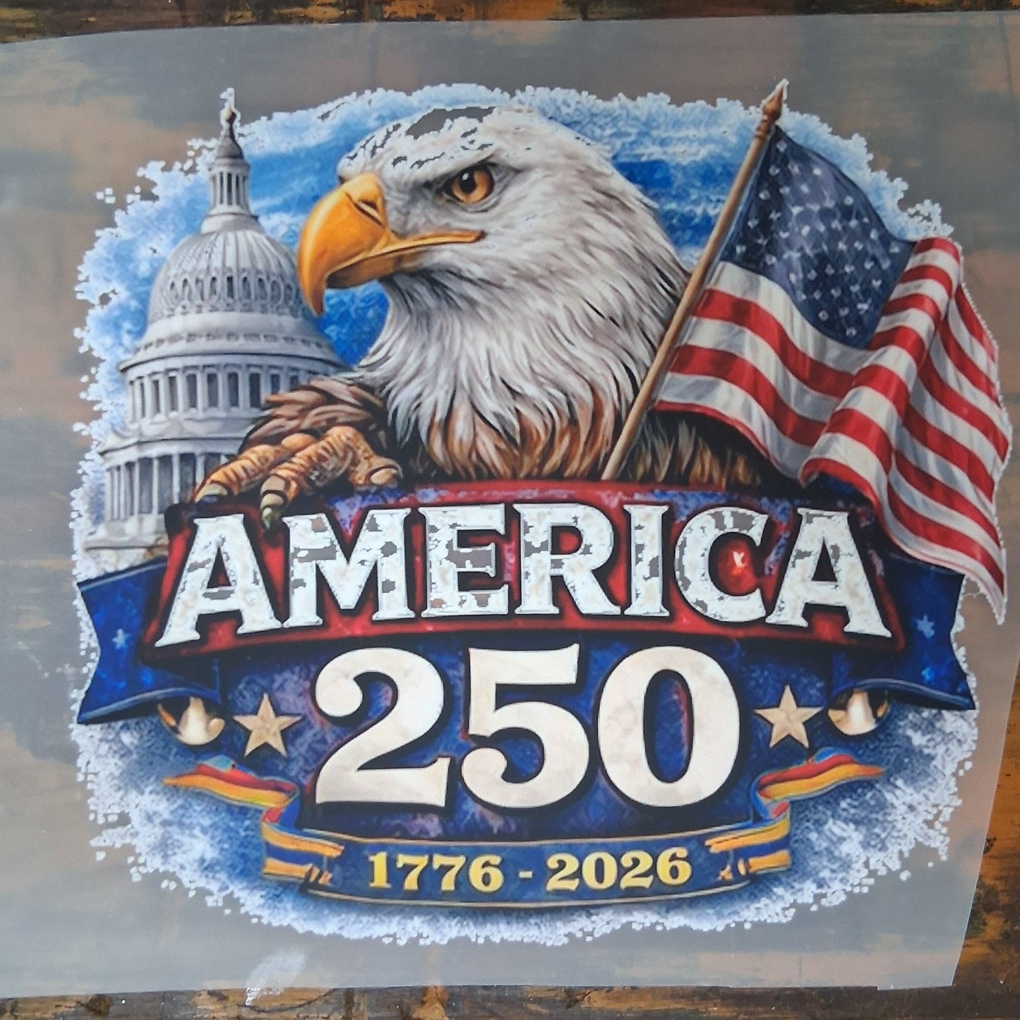 America 250 DTF Transfer Bundle - America 250 Patriotic Eagle 1776–2026 DTF Transfer on a dark wooden background 
