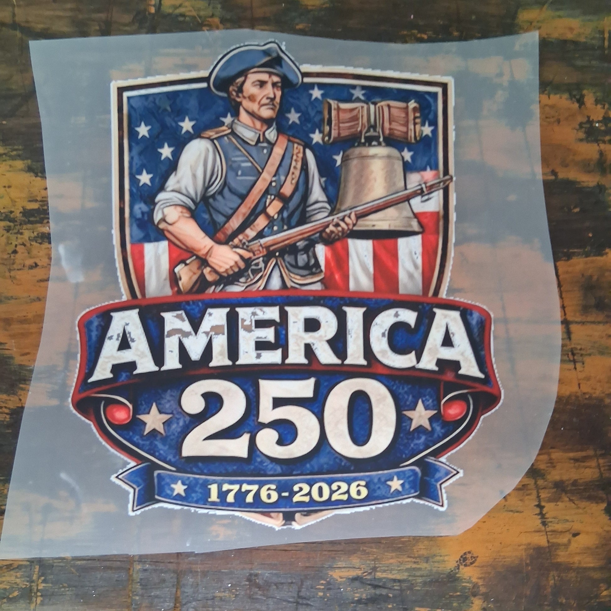 America 250 DTF Transfer Bundle - America 250 Soldier & Liberty Bell Design DTF Transfer on a dark wooden background