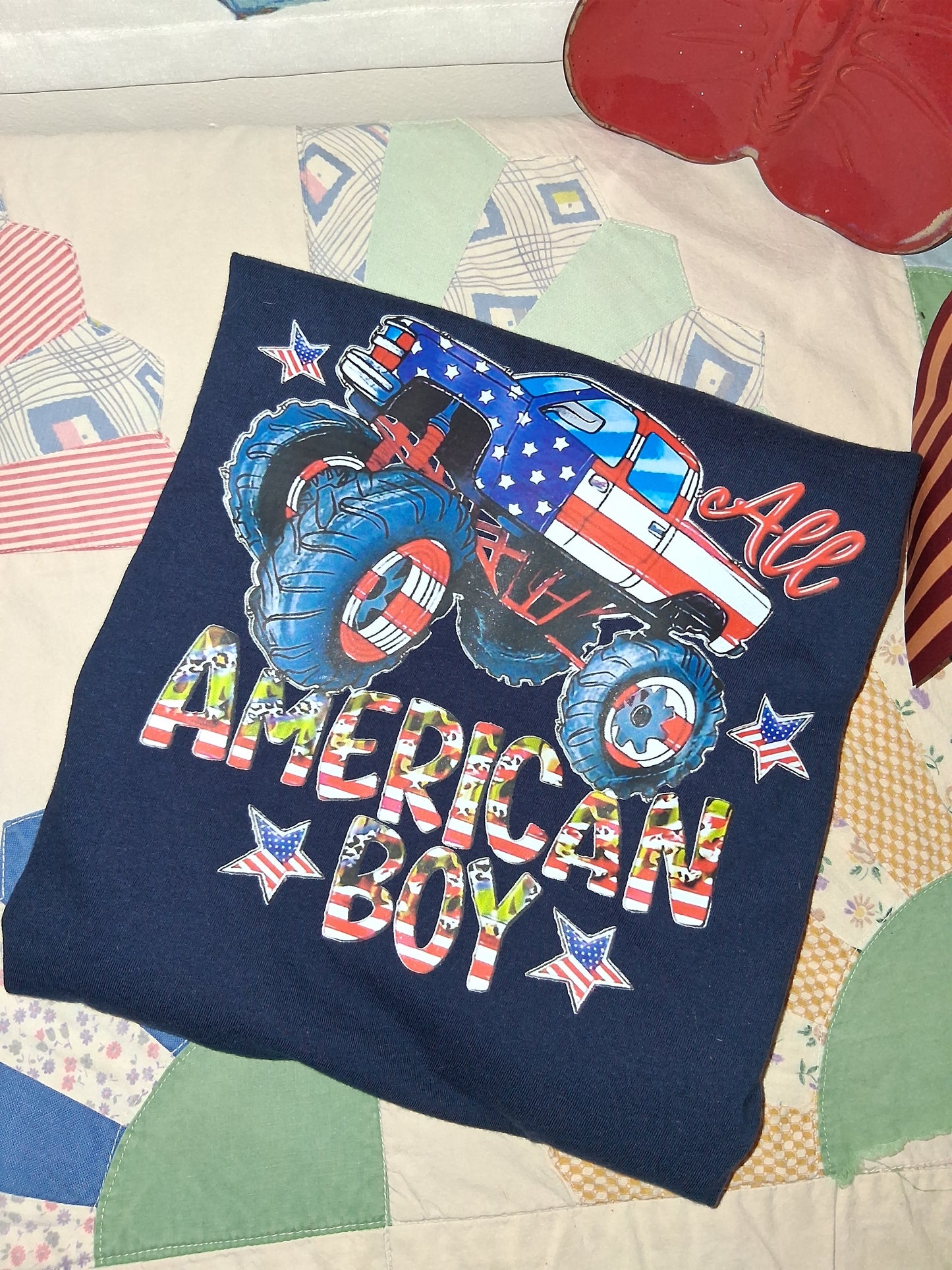 American Boy Monster Truck Tee | Youth Large on a quilted surface.