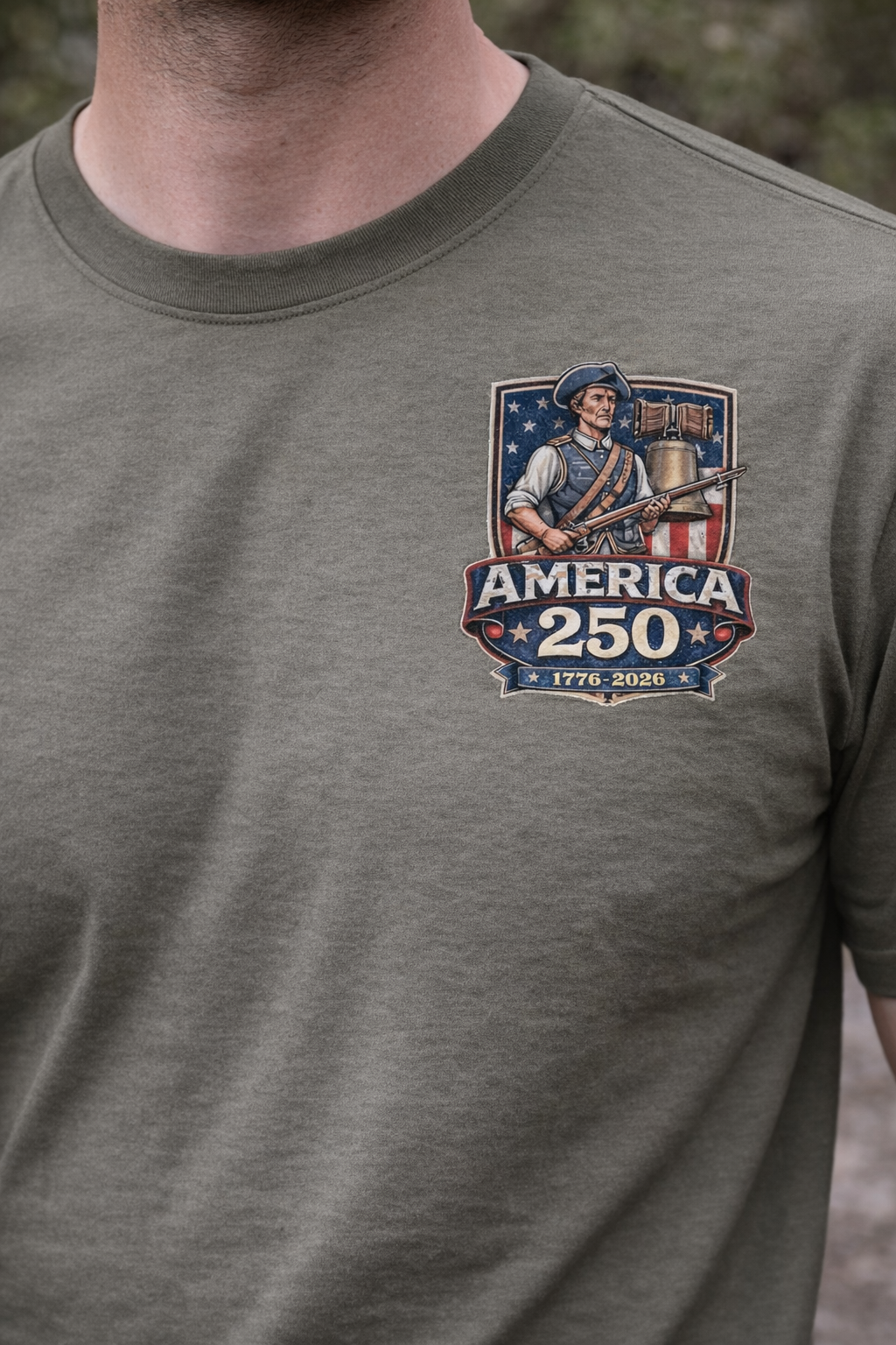 Gray t-shirt with America 250 DTF Transfer Bundle - America 250 Soldier & Liberty Bell Design DTF Transfer on a model standing outdoors