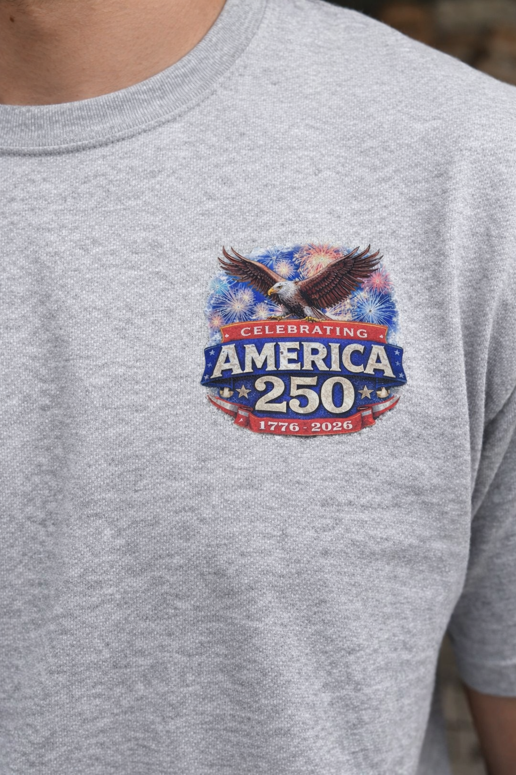 Gray t-shirt with America 250 Fireworks Eagle DTF Transfer on a model outdoors