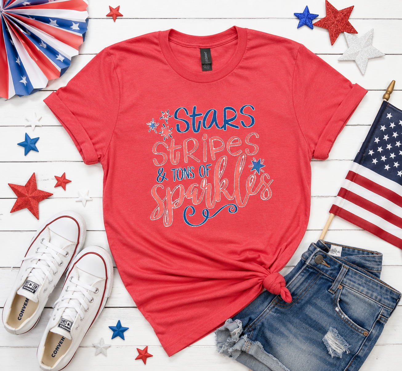 Stars, Stripes & Tons of Sparkles Tee | Women's Medium | Patriotic Graphic Tee, surrounded by American flags and shoes on a wooden surface.