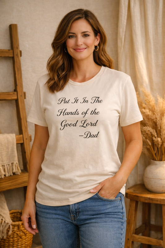 Woman wearing Hands of the Good Lord Tee, standing in a home setting.