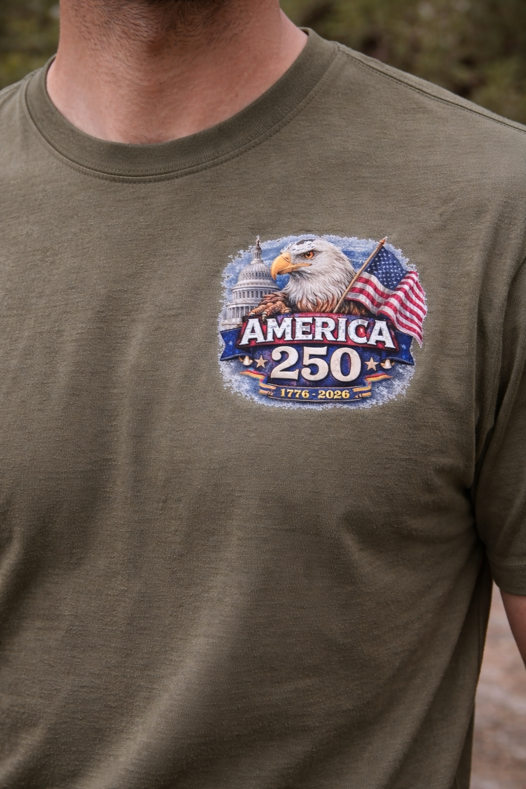 Olive green t-shirt with America 250 DTF Transfer Bundle - America 250 Patriotic Eagle 1776–2026 DTF Transfer on a model in outdoor setting