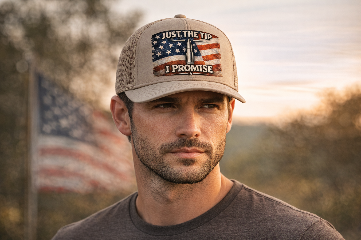 Man wearing a cap with Just the Tip I Promise American Flag/Bullet PNG File, standing in front of an American flag.