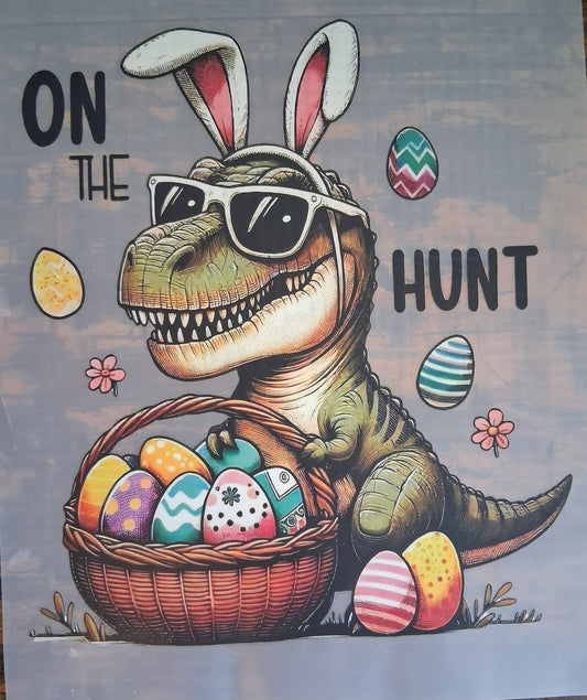 On The Hunt Easter Dinosaur DTF Transfer against a wooden background